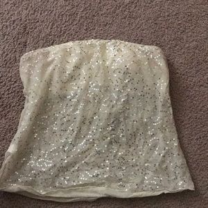 A strapless white glittery shirt